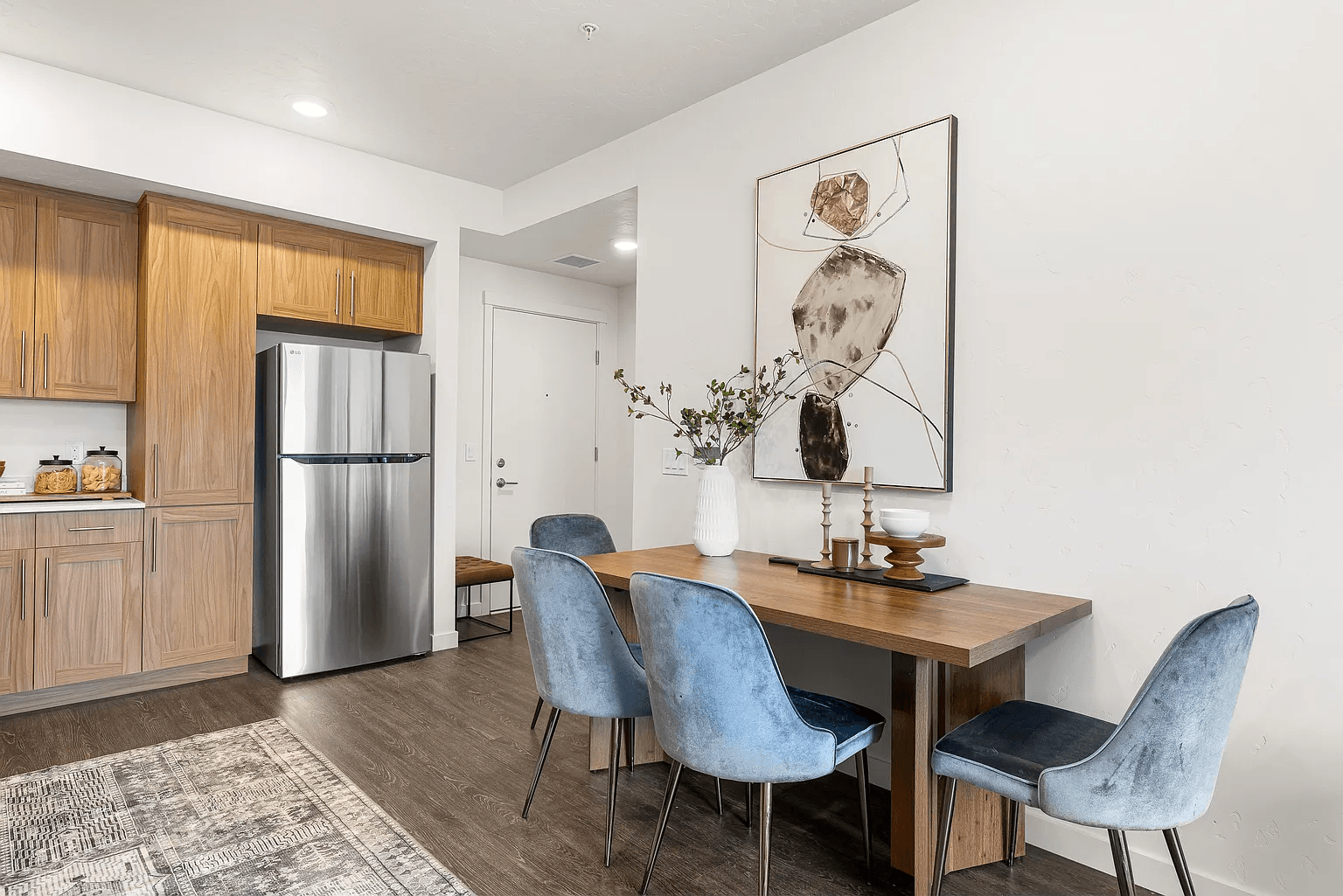 A modern kitchen with a dining table and chairs.